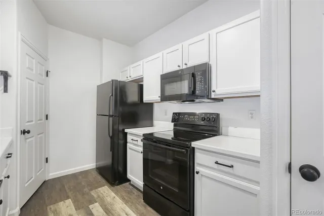 a kitchen with cabinets stainless steel appliances and a counter space