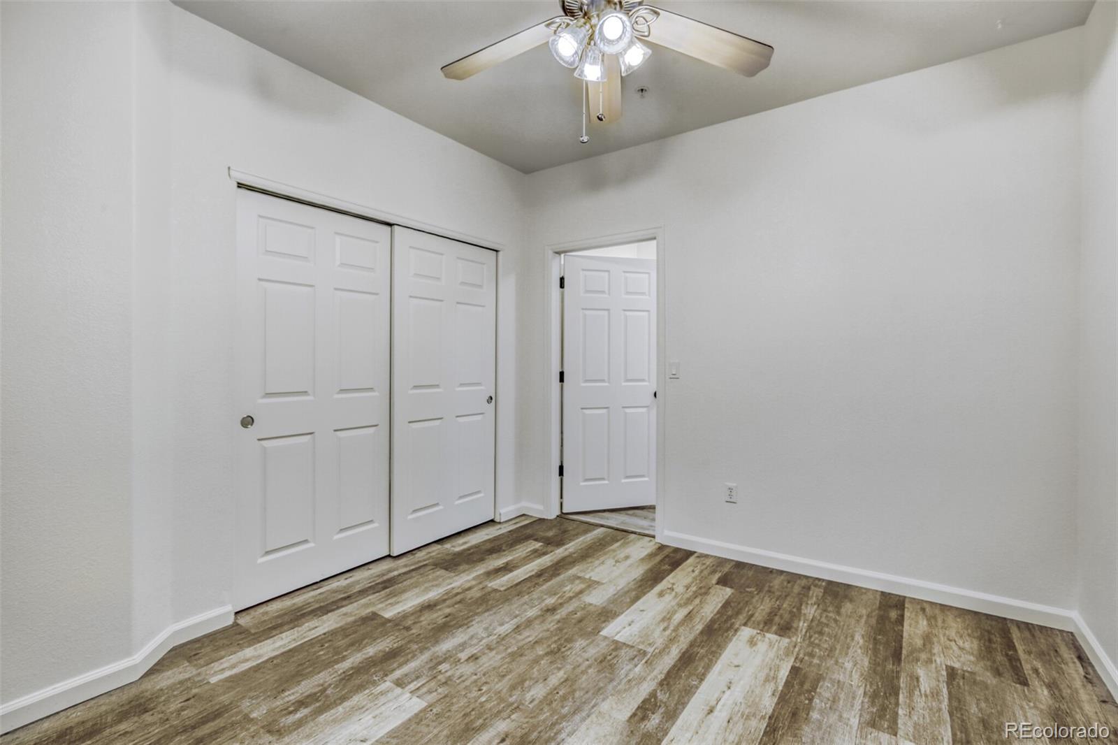 5255 Memphis Street, Unit 207 Denver, CO 80239 - Photo 7 of 21 wooden floor in an empty room