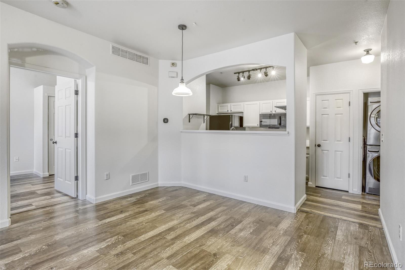 5255 Memphis Street, Unit 207 Denver, CO 80239 - Photo 9 of 21 a view of a room with wooden floor and white walls