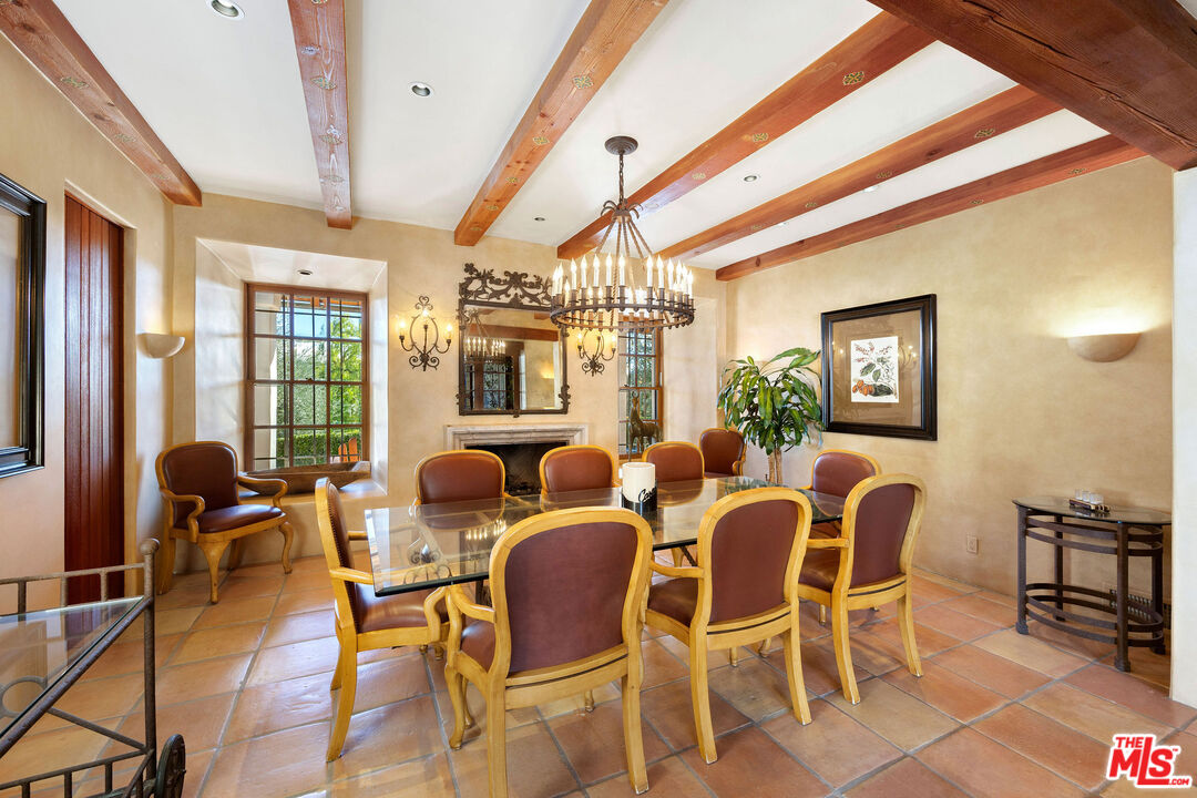 25127 Jim Bridger Road Hidden Hills, CA 91302 - Photo 16 of 50 a view of a dining room with furniture a chandelier and wooden floor
