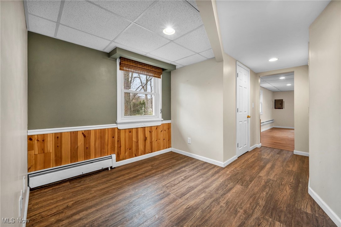 12150 Heath Road Chesterland, OH 44026 - Photo 32 of 43 Unfurnished room featuring a baseboard heating unit, recessed lighting, wood finished floors, and baseboards