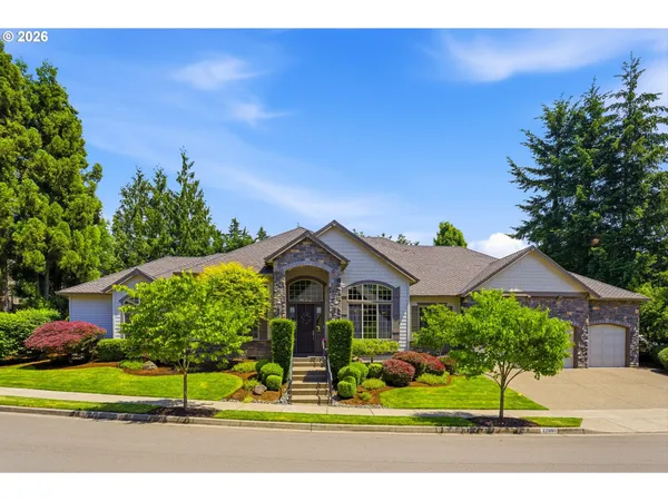a front view of a house with a garden