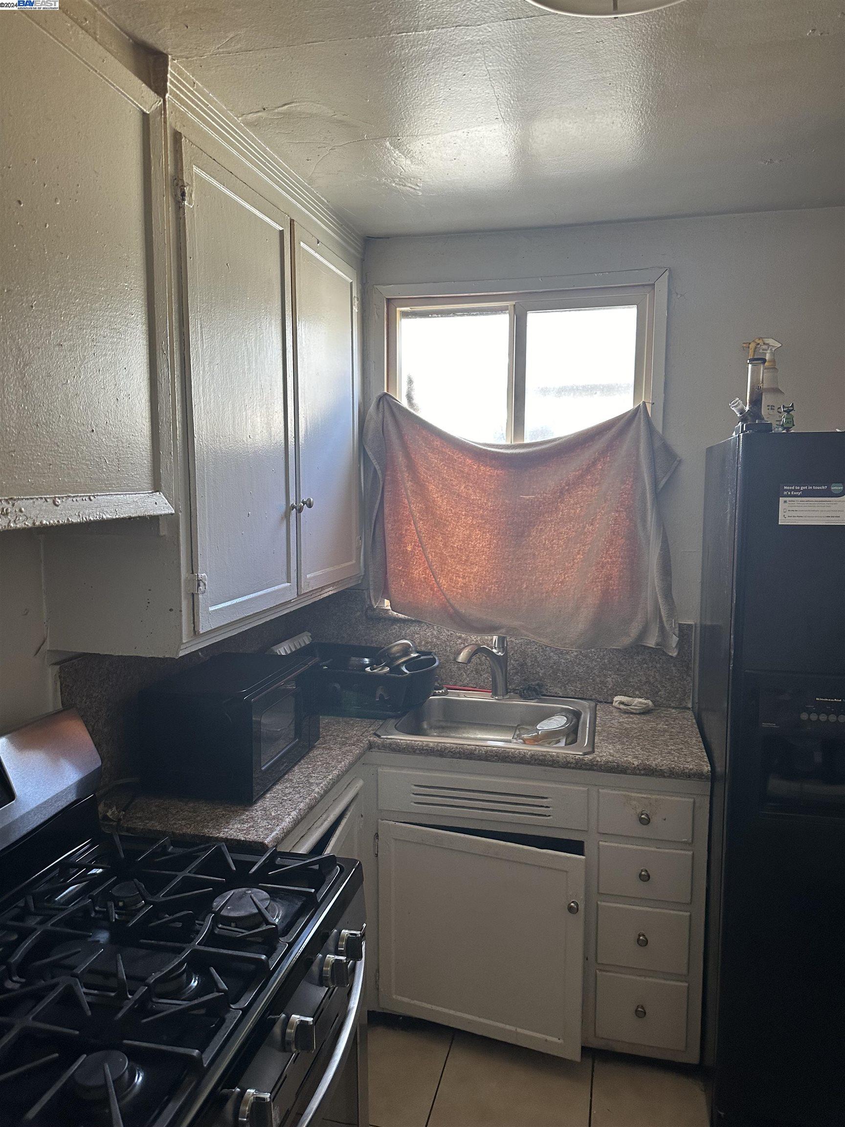5659 Telegraph Avenue Oakland, CA 94609 - Photo 22 of 42 a kitchen with granite countertop a stove and a sink