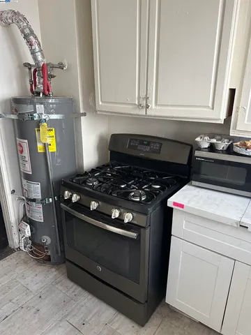 a kitchen with a stove a sink and a window