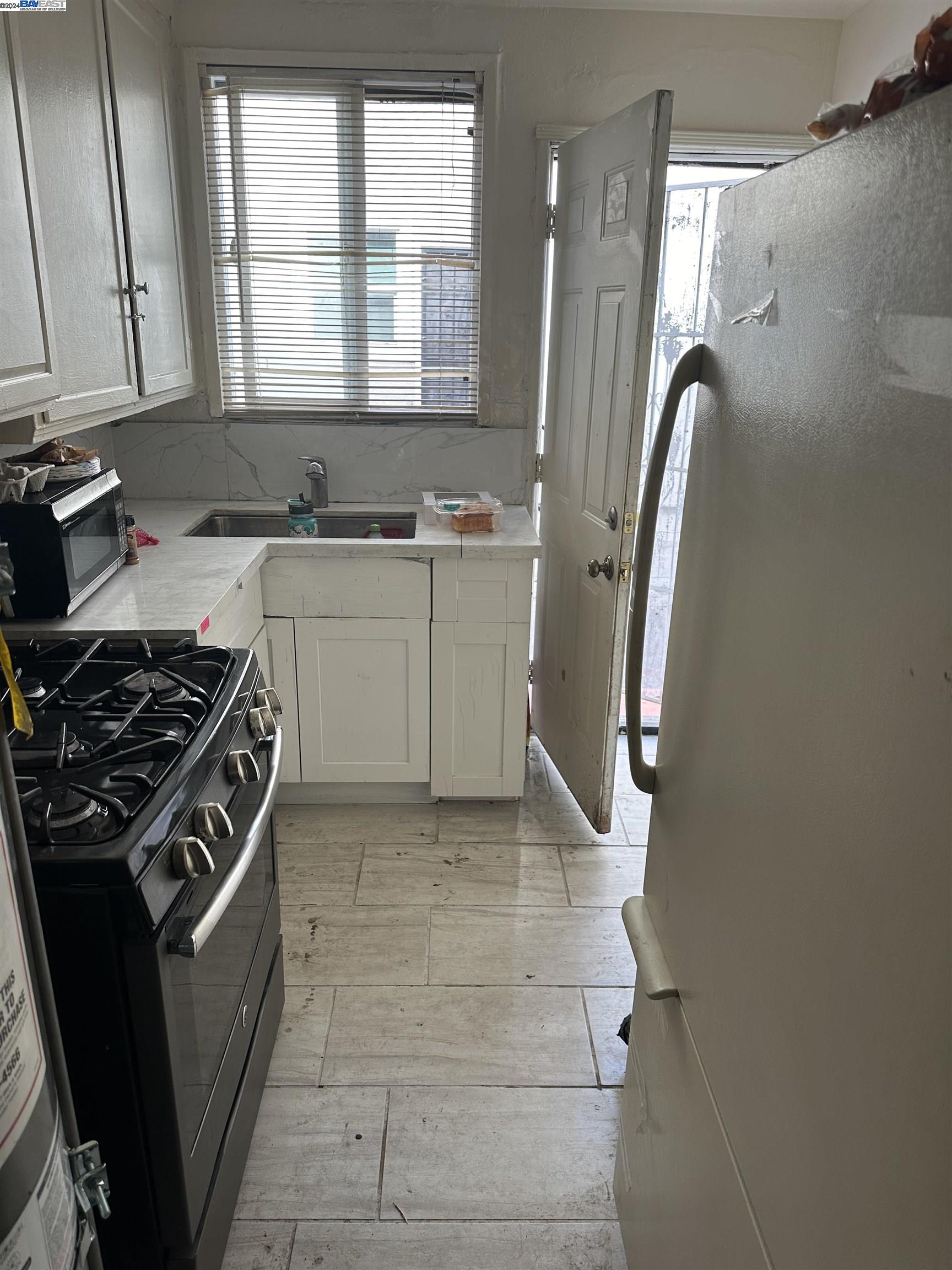 5659 Telegraph Avenue Oakland, CA 94609 - Photo 26 of 42 a kitchen with a stove a sink and a window