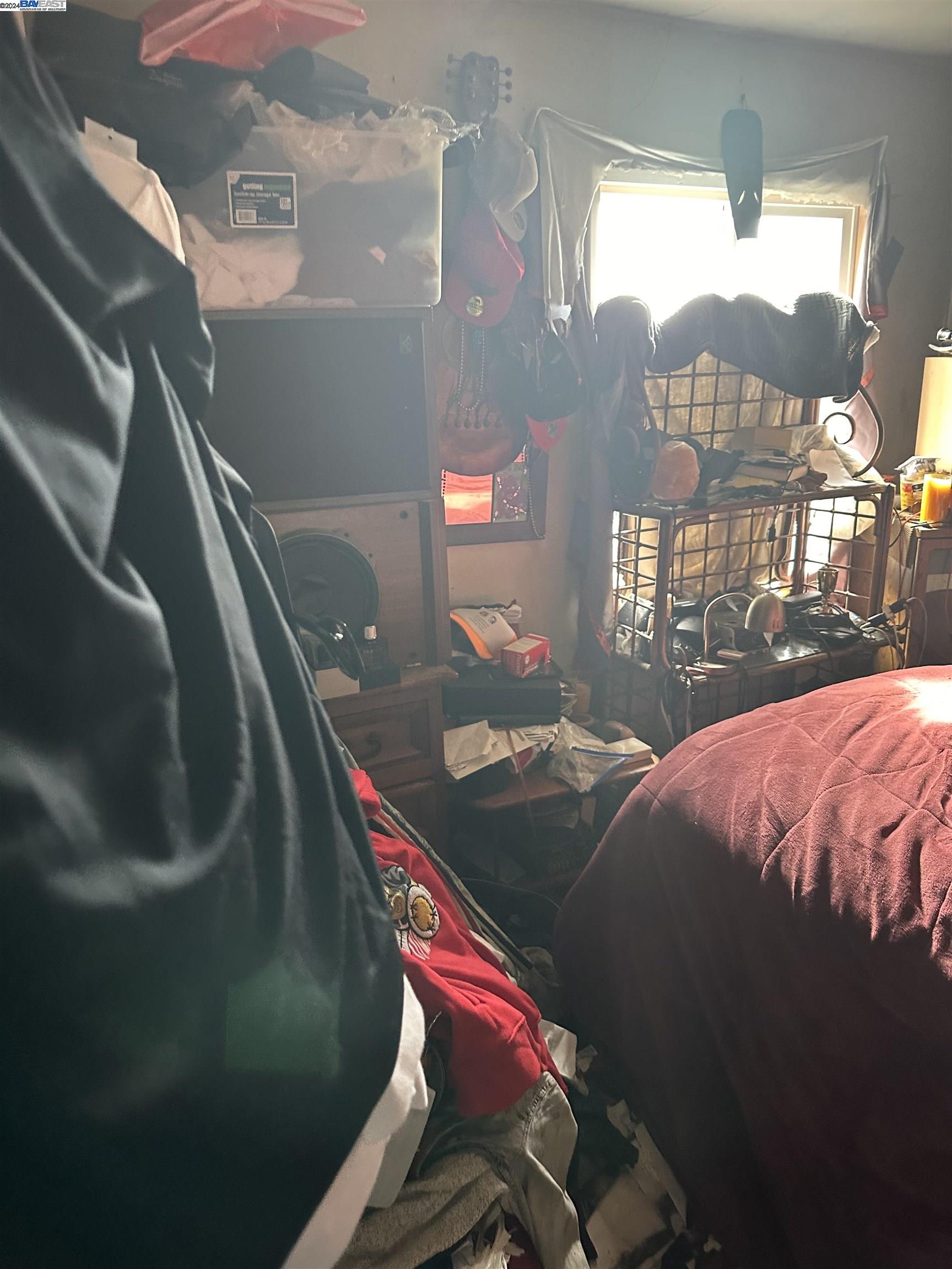 5659 Telegraph Avenue Oakland, CA 94609 - Photo 28 of 42 a bedroom with a bed and a chandelier