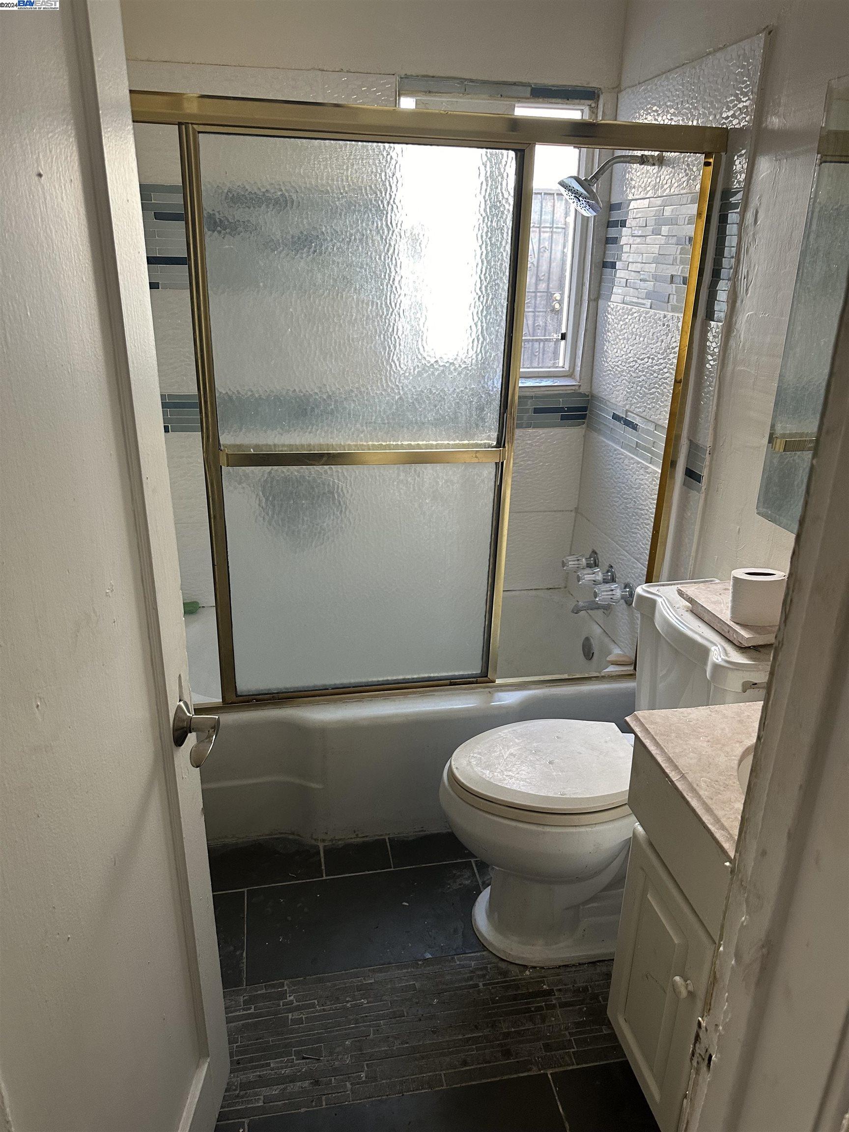 5659 Telegraph Avenue Oakland, CA 94609 - Photo 31 of 42 a white toilet sitting next to a shower
