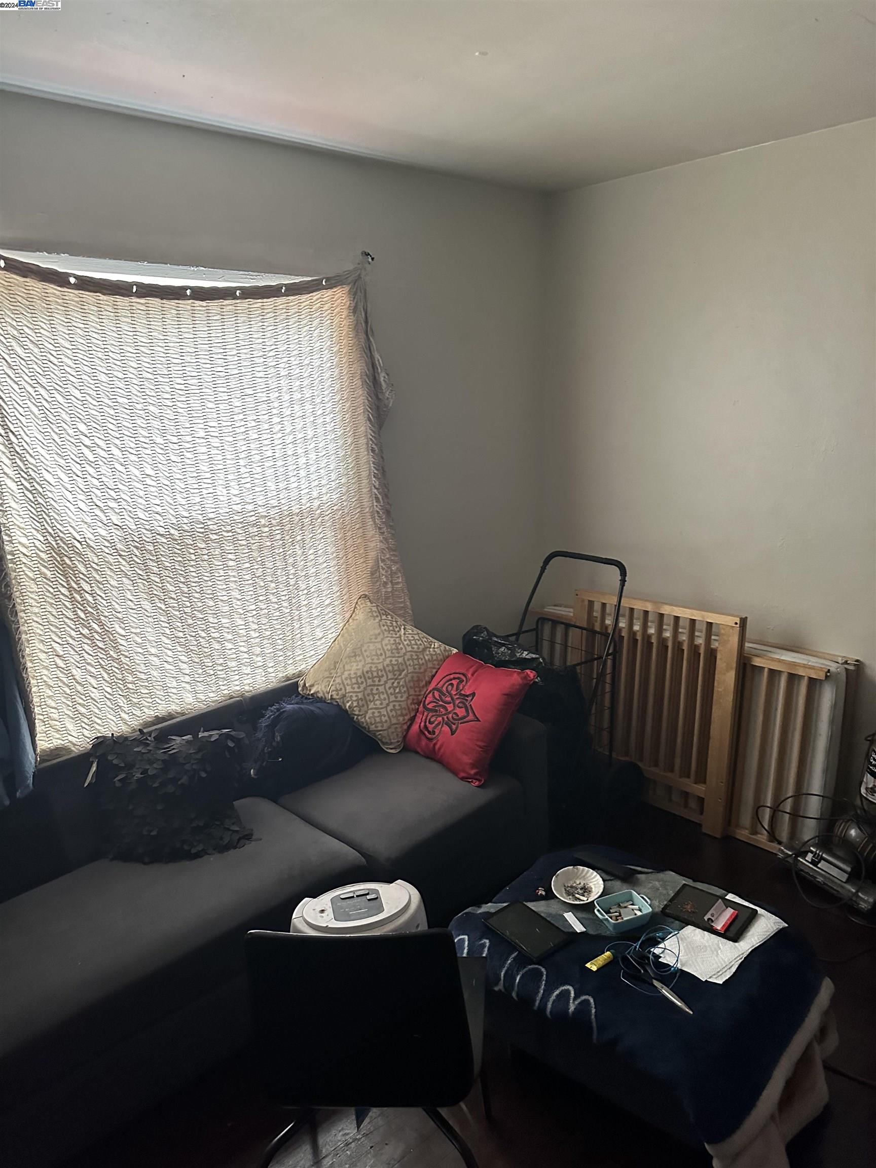 5659 Telegraph Avenue Oakland, CA 94609 - Photo 32 of 42 a living room with furniture and a couch