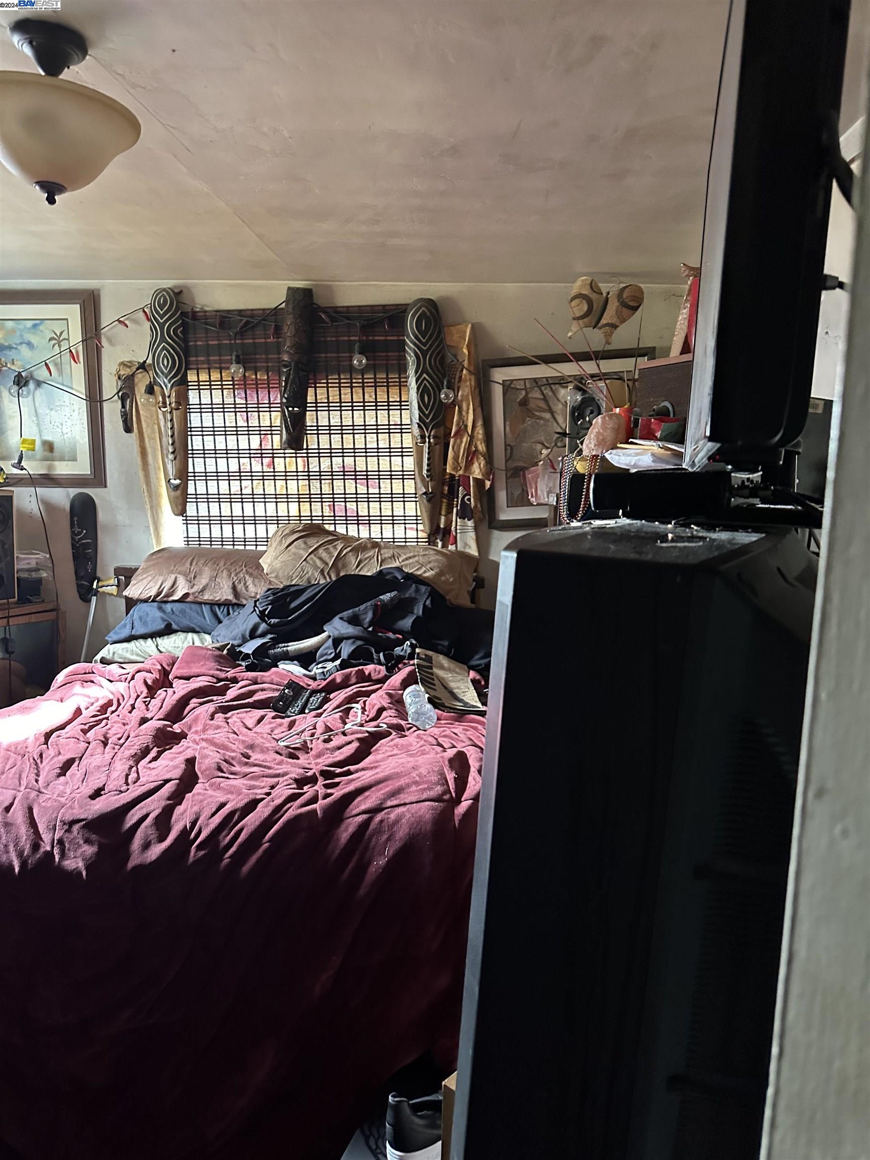 5659 Telegraph Avenue Oakland, CA 94609 - Photo 42 of 42 a bed sitting in a bedroom next to a window