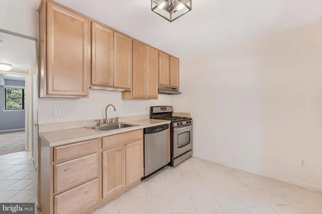 a kitchen with stainless steel appliances granite countertop a sink and a stove