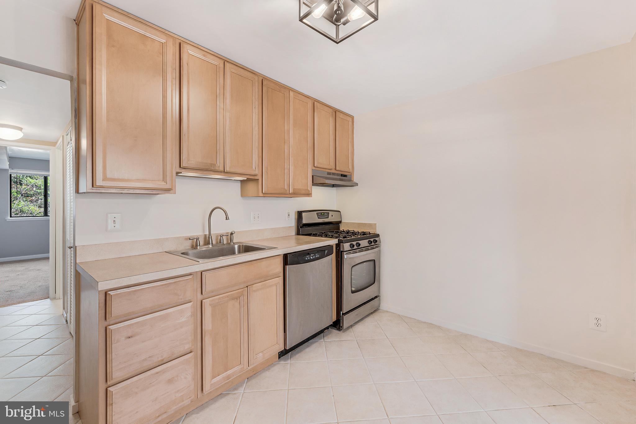 1623 Parkcrest Circle, Unit 9B/300 Reston, VA 20190 - Photo 13 of 32 a kitchen with stainless steel appliances granite countertop a sink and a stove