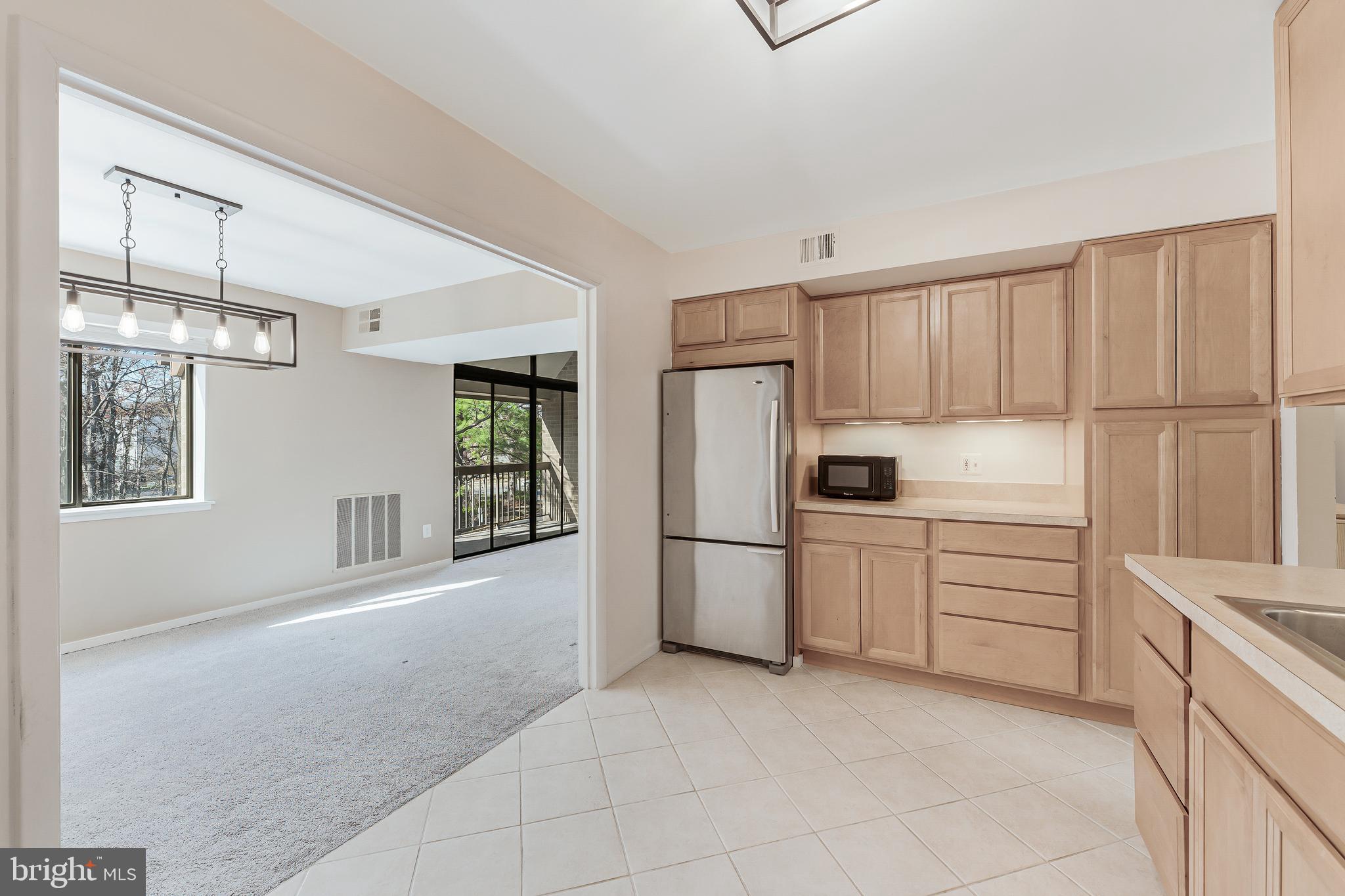 1623 Parkcrest Circle, Unit 9B/300 Reston, VA 20190 - Photo 15 of 32 a kitchen with white cabinets and white appliances