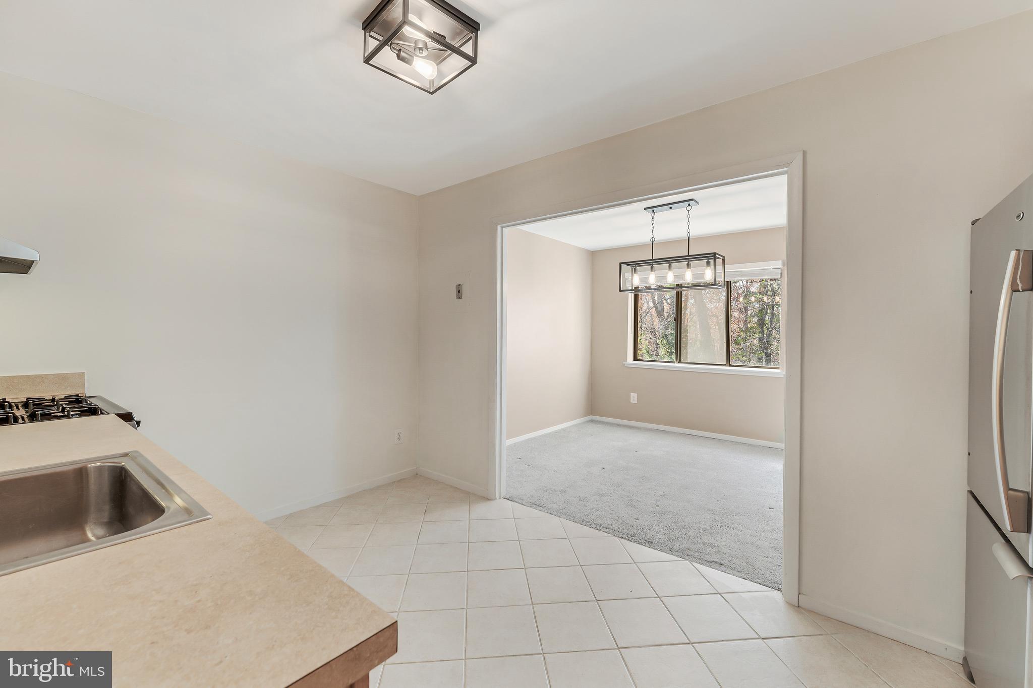 1623 Parkcrest Circle, Unit 9B/300 Reston, VA 20190 - Photo 16 of 32 a view of a kitchen with a sink cabinets and a window