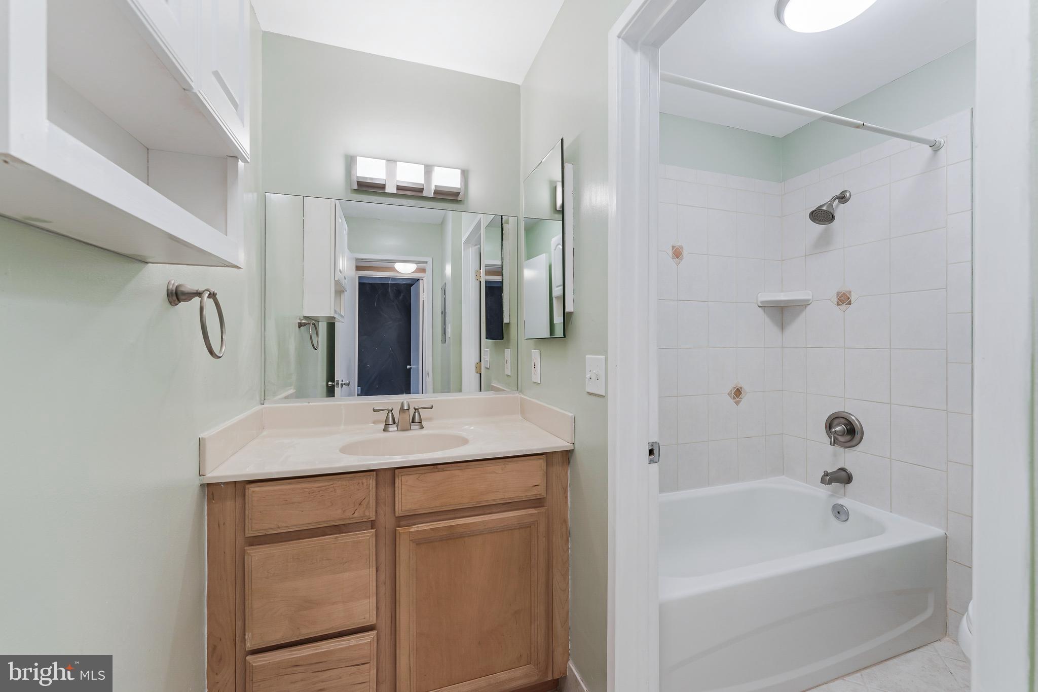 1623 Parkcrest Circle, Unit 9B/300 Reston, VA 20190 - Photo 22 of 32 a bathroom with a sink tub vanity and a mirror