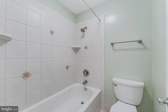 a bathroom with a bathtub and toilet