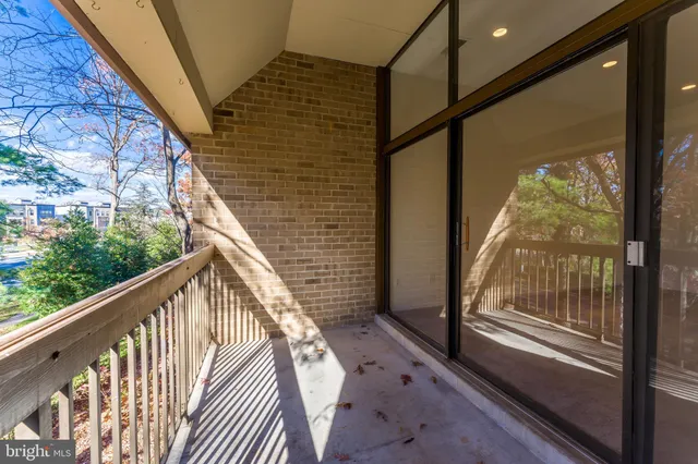 a view of balcony with wooden floor and fence