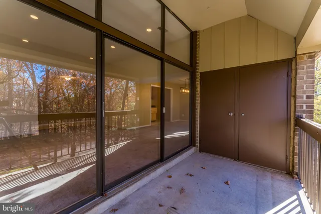 a view of empty room with wooden floor and floor to ceiling window