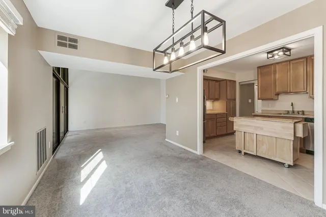 a view of a kitchen with a sink and a refrigerator