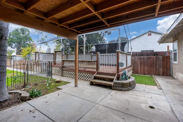 a view of backyard with wooden fence