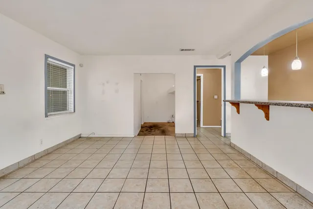 a view of an empty room and a window