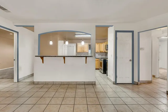 a view of a hallway with wooden cabinets