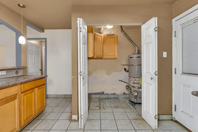 a bathroom with a granite countertop sink mirror and a toilet