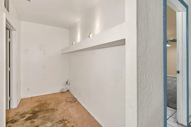 a view of a room with wooden floor