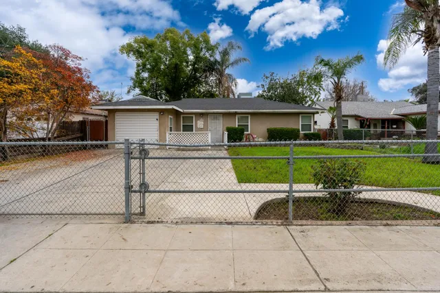 a view of a patio with a table and chairs under an umbrella