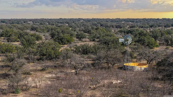 a view of a field with trees in background
