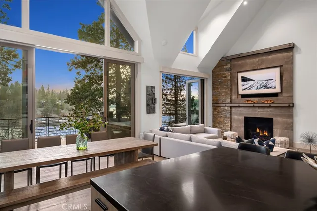 a living room with furniture large window and a fireplace