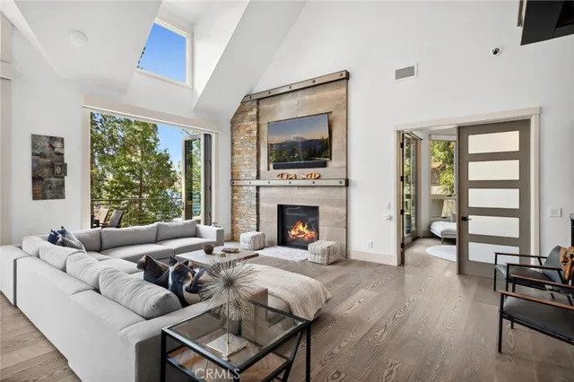 a living room with furniture large window and a fireplace