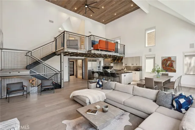 a living room with furniture or wooden floor and a ceiling fan