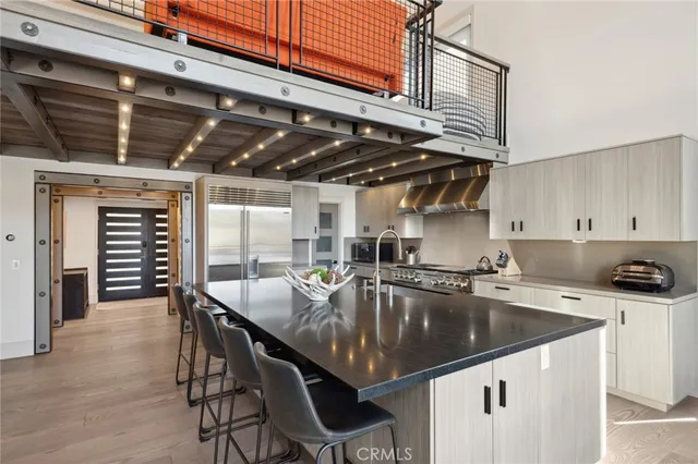 a kitchen with a table chairs and cabinets