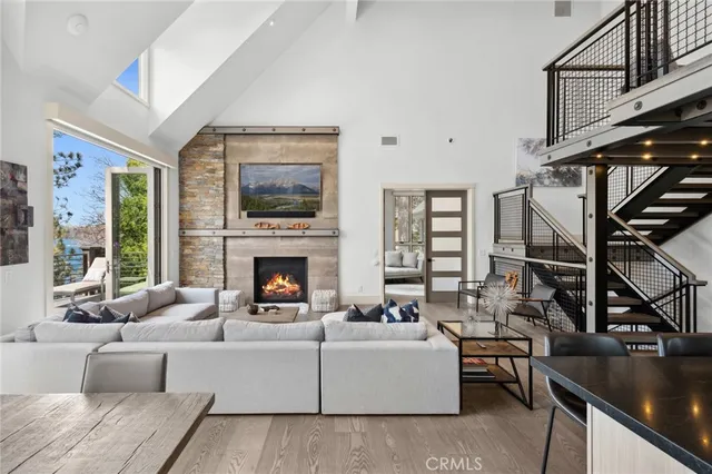 a living room with furniture a fireplace and a large window