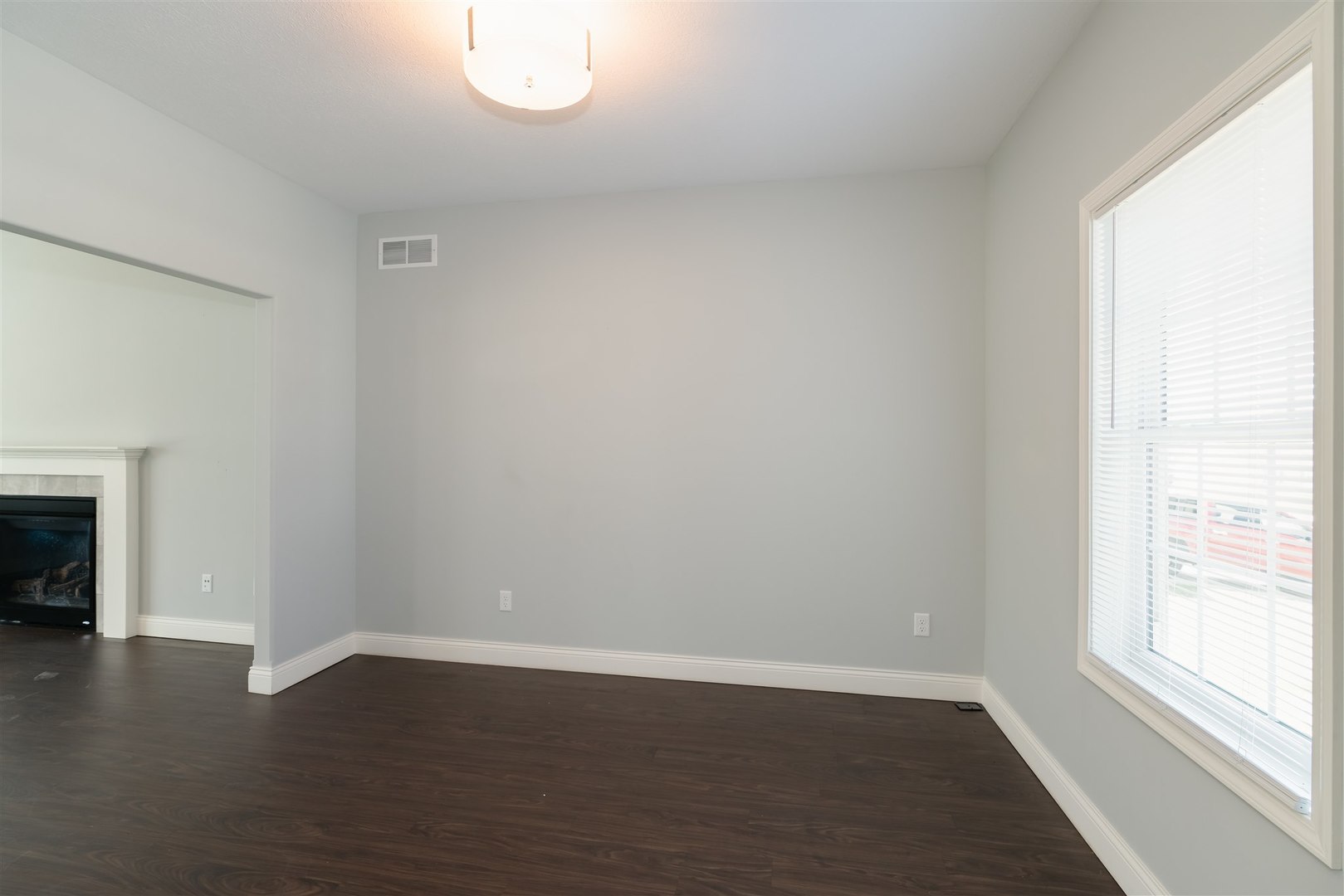 2514 Grey Fox Trail Bloomington, IL 61705 - Photo 3 of 37 an empty room with wooden floor and a window