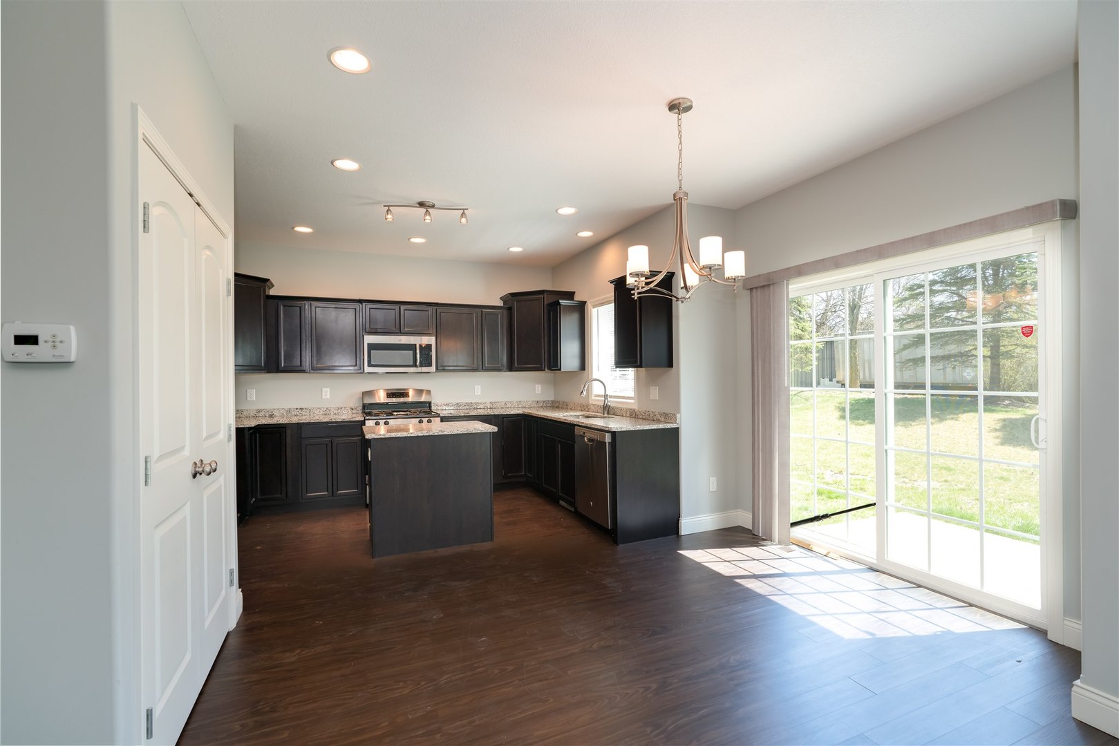 2514 Grey Fox Trail Bloomington, IL 61705 - Photo 6 of 37 a large kitchen with kitchen island a large counter top a sink stainless steel appliances and cabinets