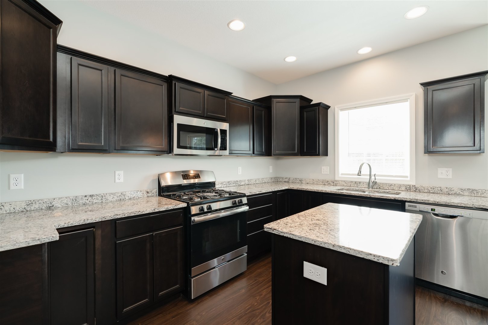 2514 Grey Fox Trail Bloomington, IL 61705 - Photo 8 of 37 a kitchen that has a sink and a stove top oven