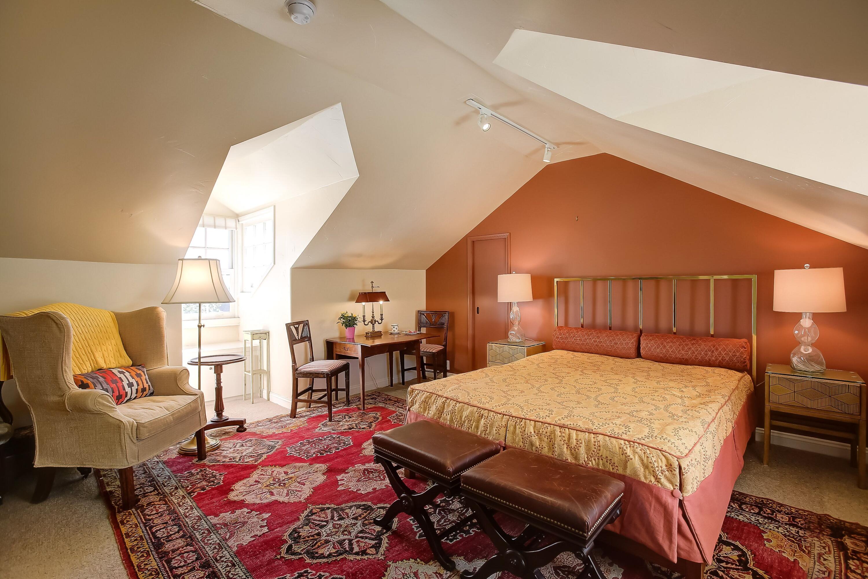 544 San Ysidro Road, Unit B Montecito, CA 93108 - Photo 13 of 18 a bedroom with a bed a table and chair