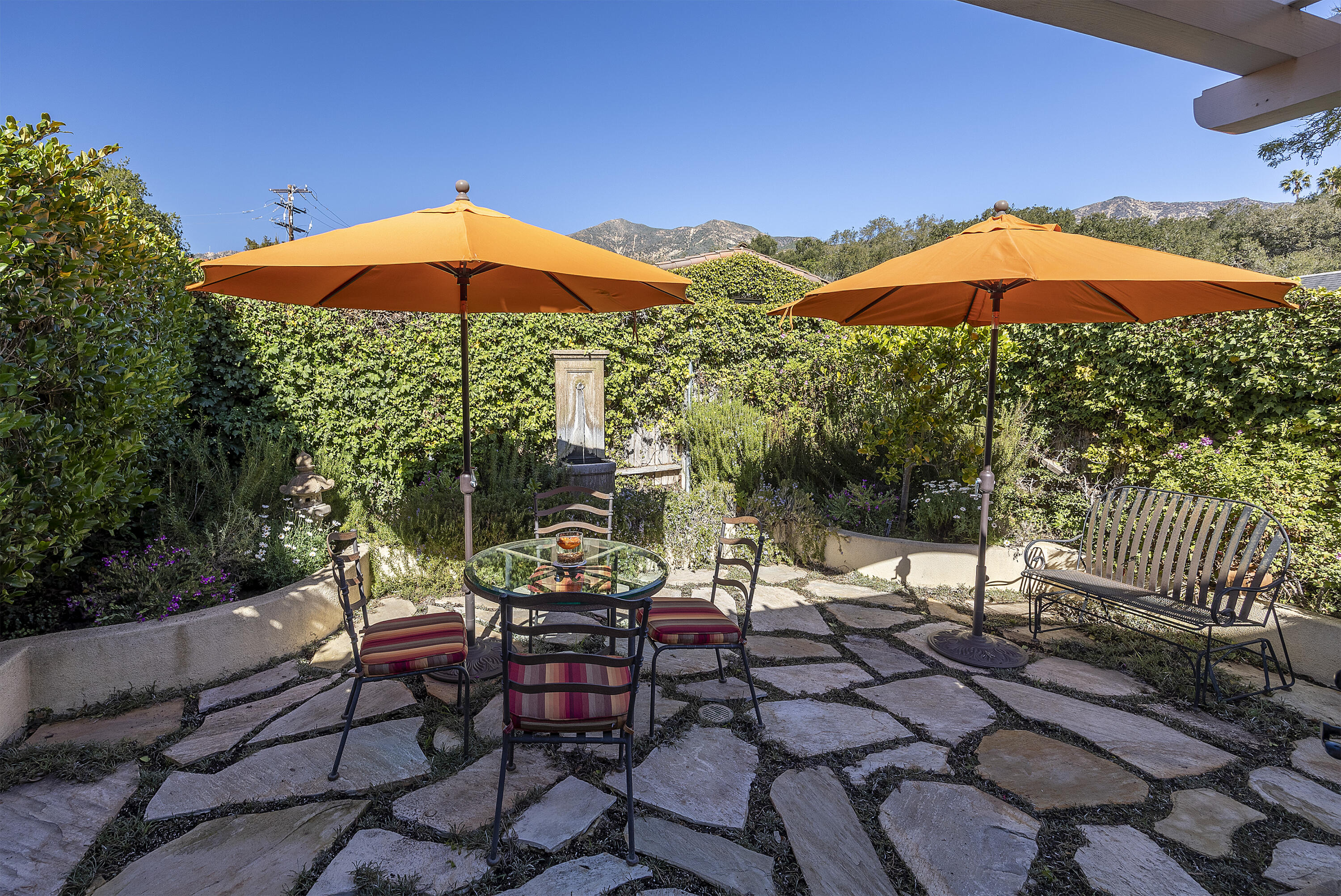 544 San Ysidro Road, Unit B Montecito, CA 93108 - Photo 16 of 18 a view of patio with chairs and table under an umbrella