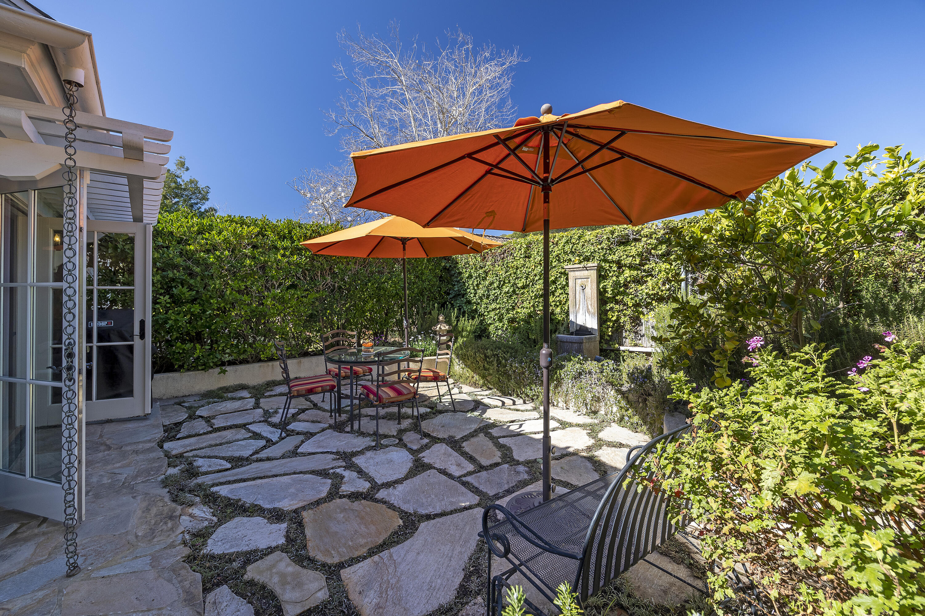 544 San Ysidro Road, Unit B Montecito, CA 93108 - Photo 17 of 18 a view of a chair and tables in the backyard