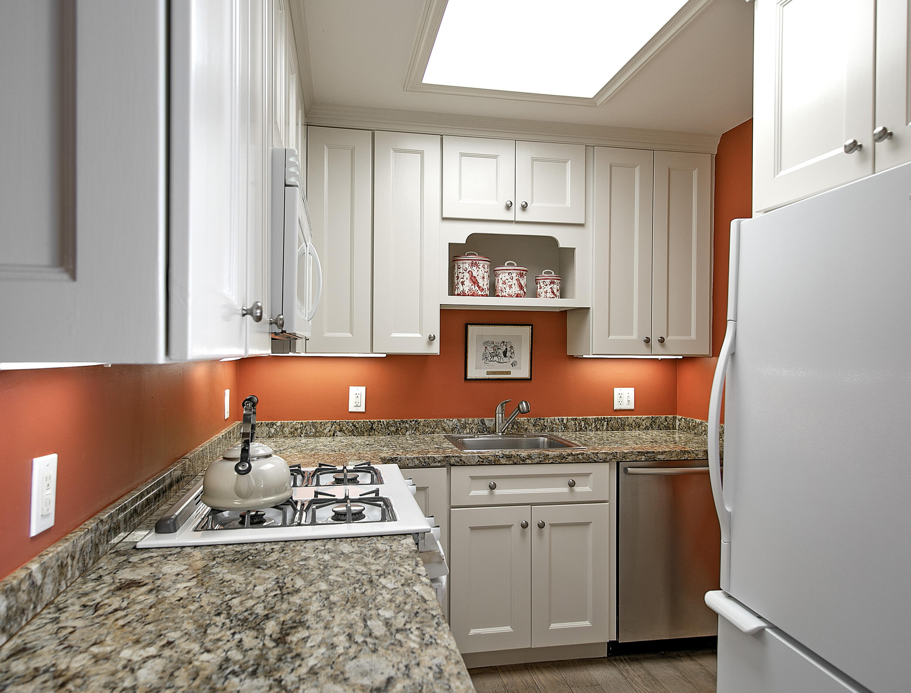 544 San Ysidro Road, Unit B Montecito, CA 93108 - Photo 9 of 18 a kitchen with stainless steel appliances granite countertop a stove a sink and a microwave
