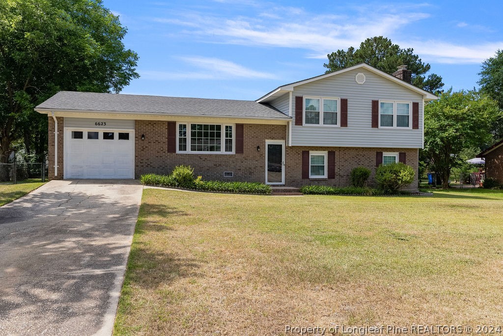 6623 Grist Mill Road Fayetteville, NC 28314 - Photo 1 of 15 a front view of a house with a yard