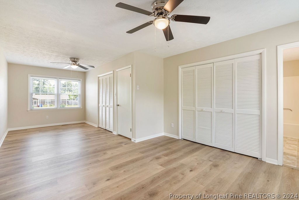 6623 Grist Mill Road Fayetteville, NC 28314 - Photo 9 of 15 an empty room with wooden floor closet and windows