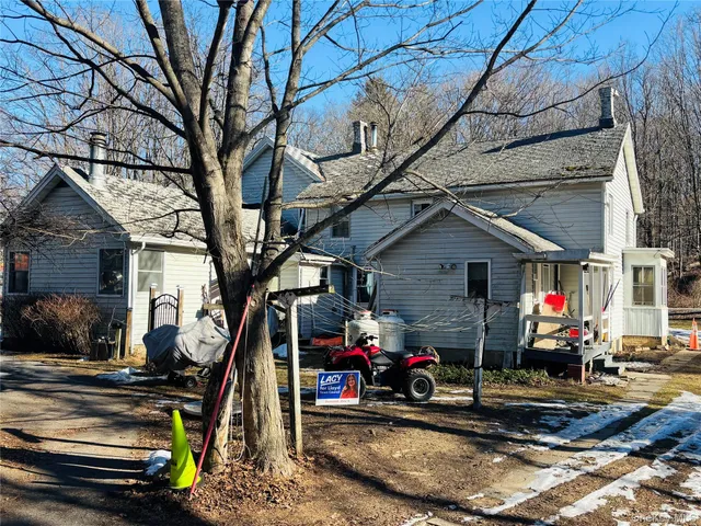 a view of a garage with a wooden fence