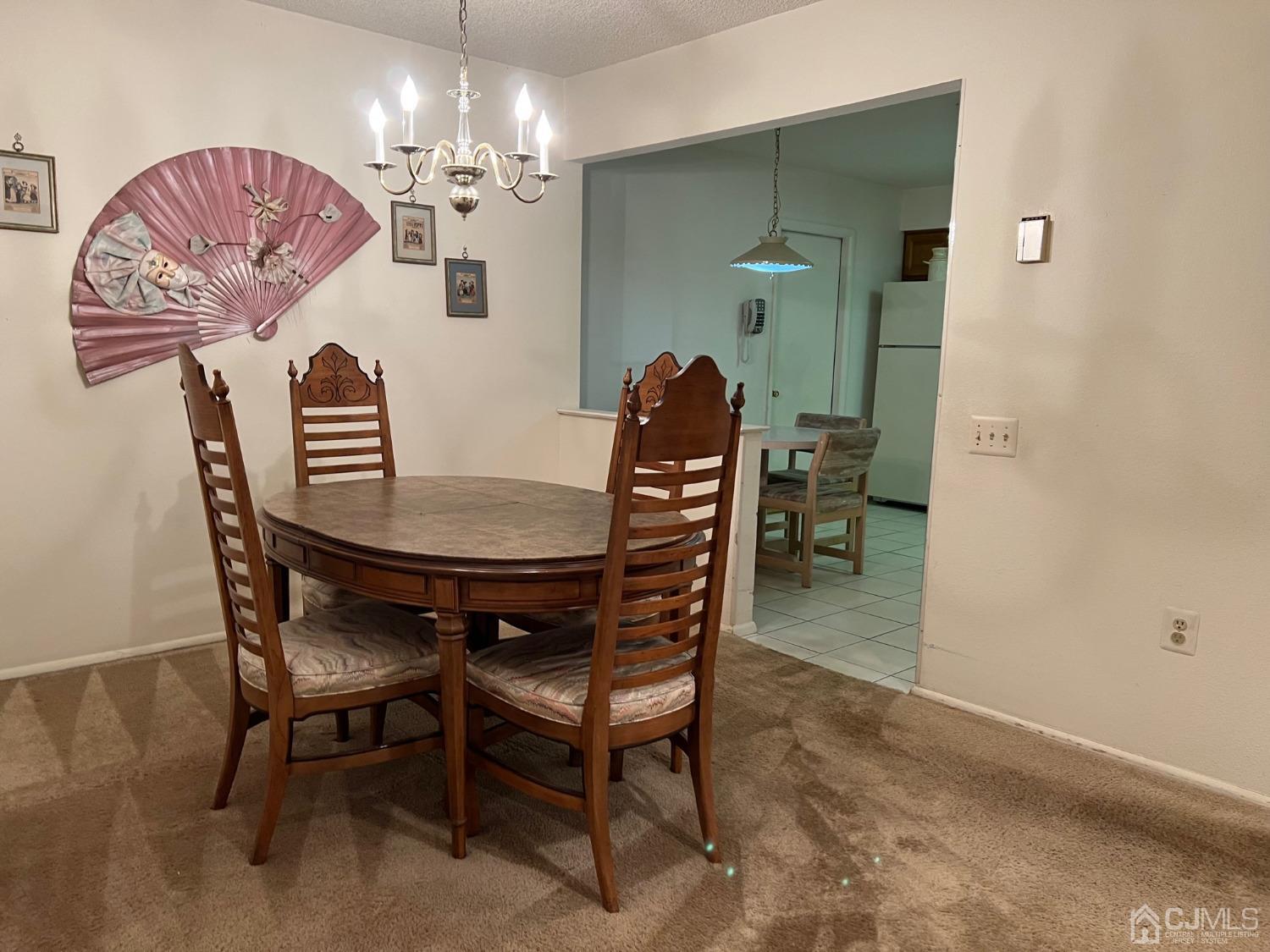 783B Risley Road, Unit A Monroe Township, NJ 08831 - Photo 13 of 30 a dining room with furniture and chandelier