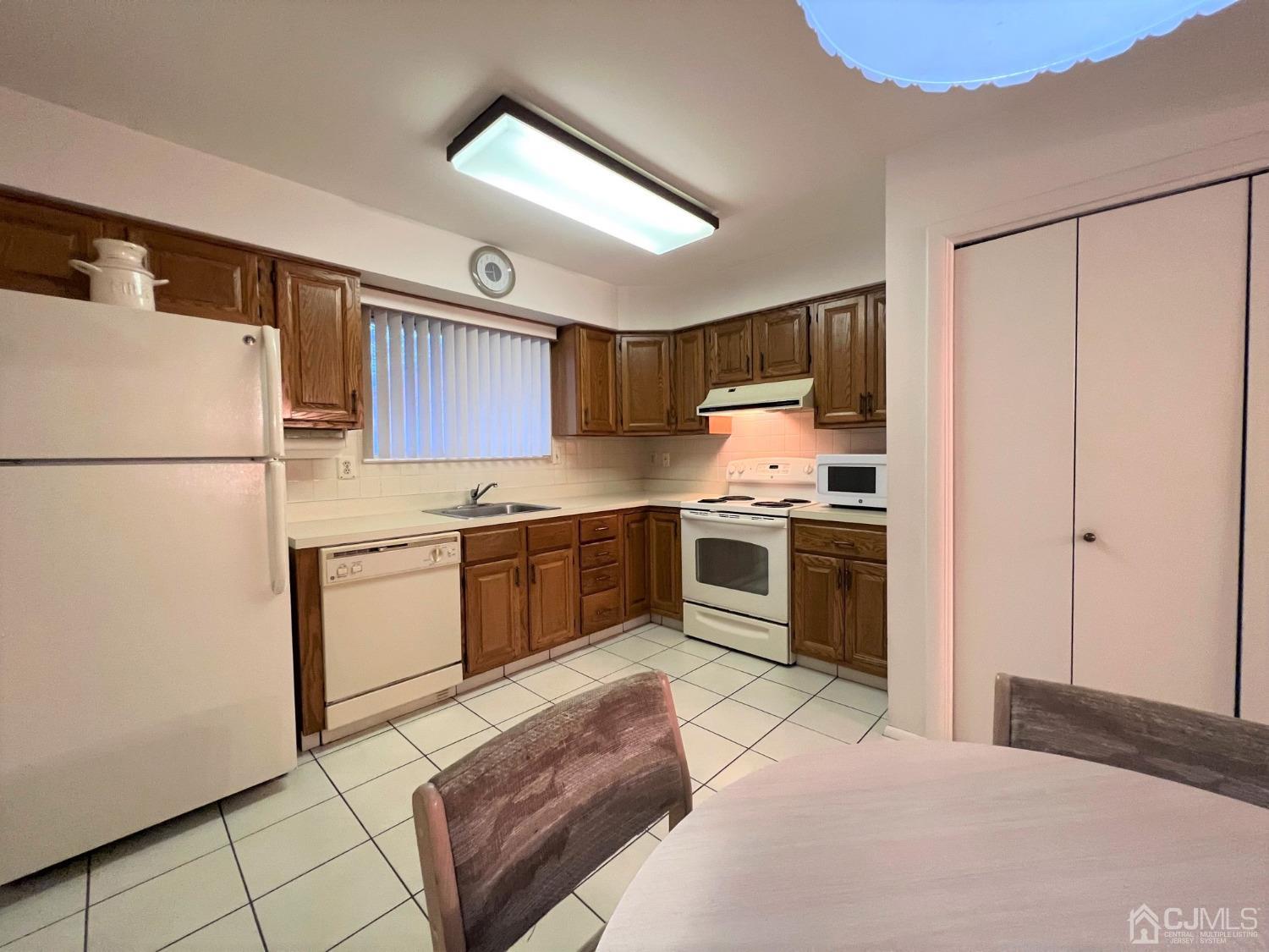 783B Risley Road, Unit A Monroe Township, NJ 08831 - Photo 15 of 30 a kitchen with stainless steel appliances granite countertop a refrigerator sink and stove