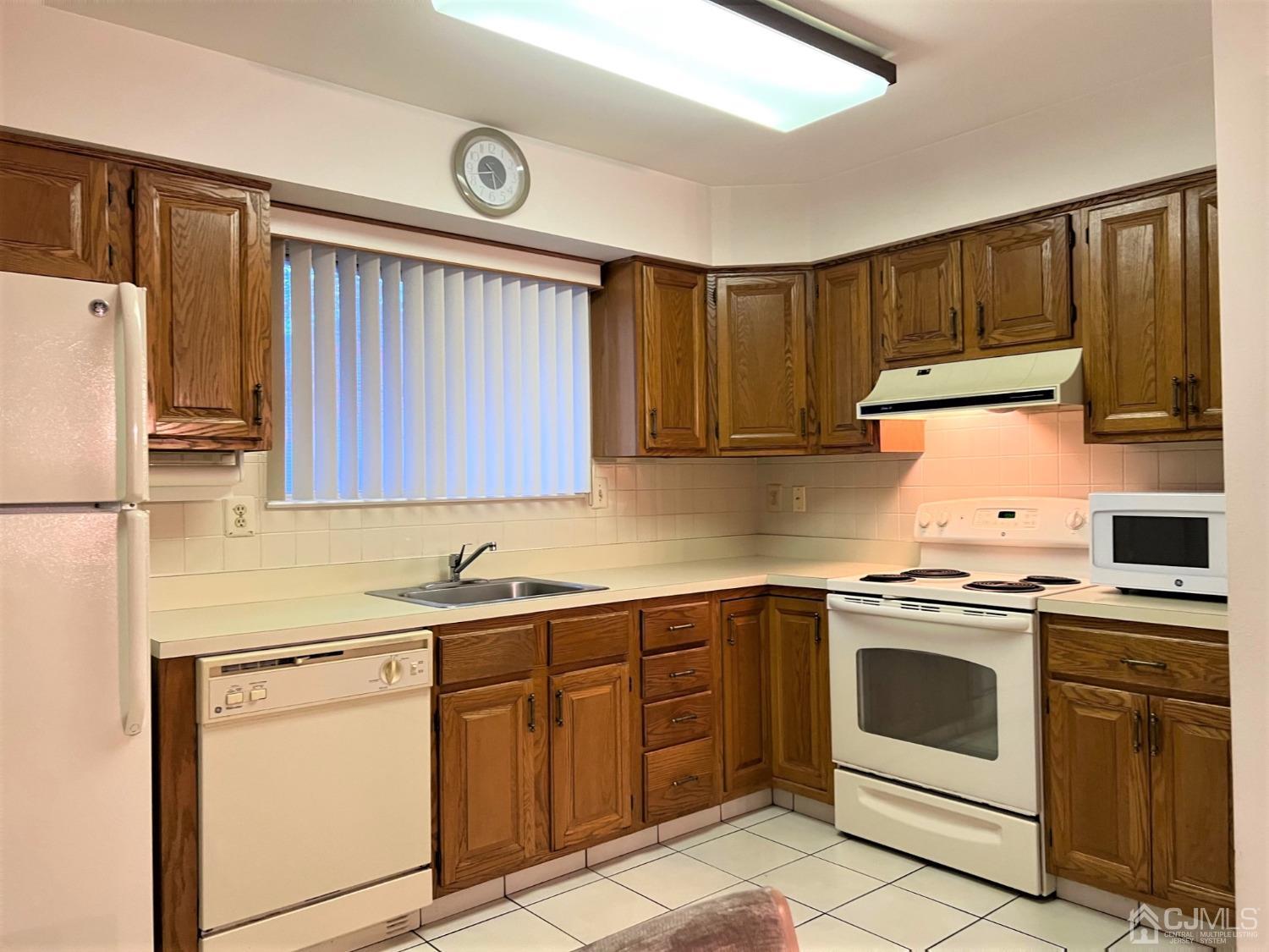 783B Risley Road, Unit A Monroe Township, NJ 08831 - Photo 17 of 30 a kitchen with a sink stove and microwave