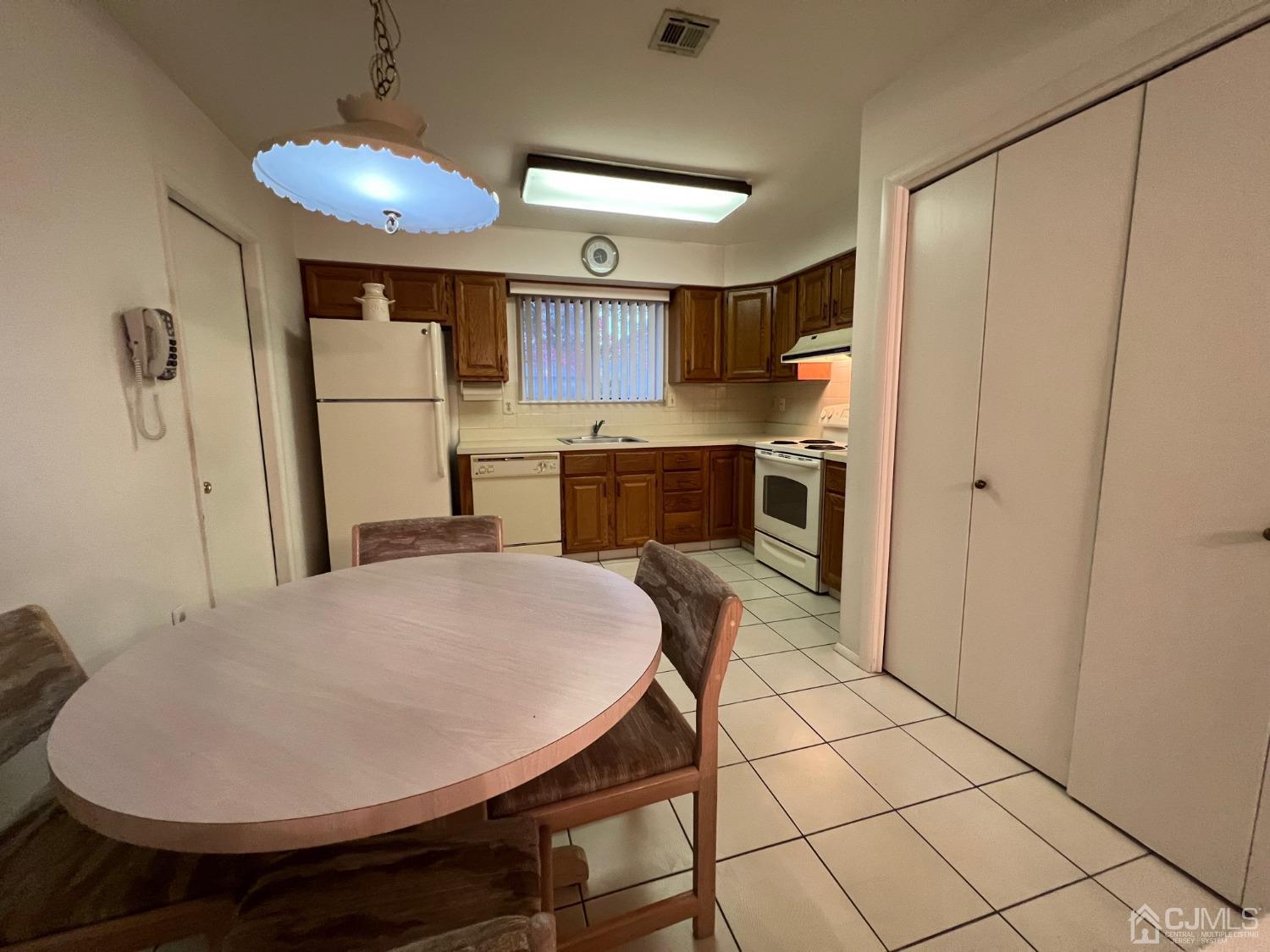 783B Risley Road, Unit A Monroe Township, NJ 08831 - Photo 19 of 30 a kitchen with stainless steel appliances a stove a refrigerator and a table