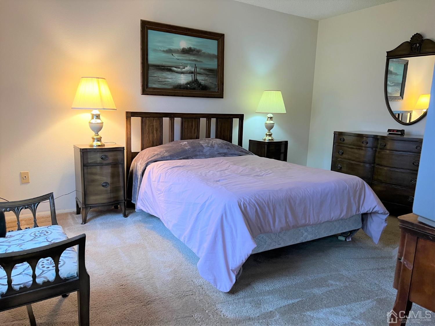 783B Risley Road, Unit A Monroe Township, NJ 08831 - Photo 22 of 30 a bedroom with a bed a dresser and painting on the wall