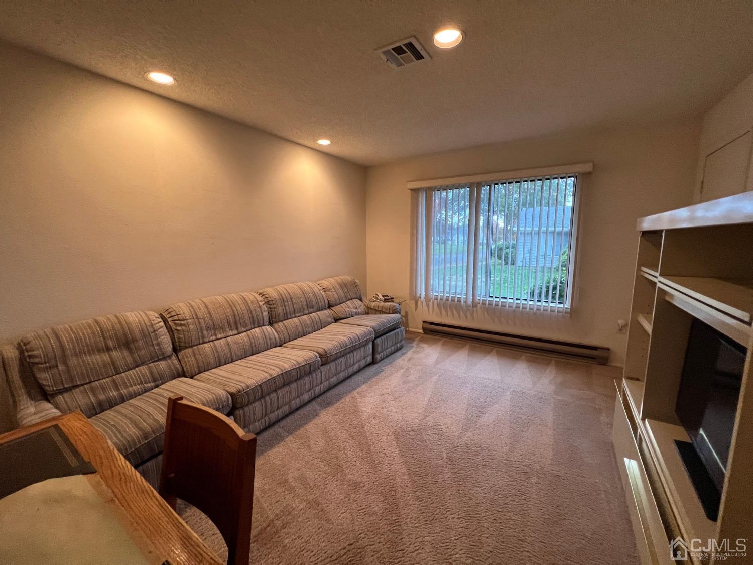 783B Risley Road, Unit A Monroe Township, NJ 08831 - Photo 27 of 30 a living room with couches and a flat screen tv